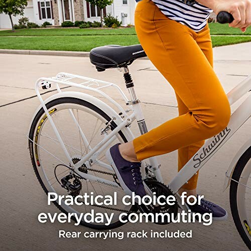 Person in orange pants on bicycle with rear carrying rack